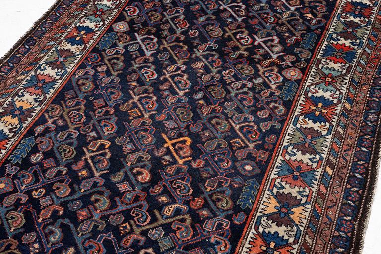 An oriental rug, c. 232 x 125 cm.