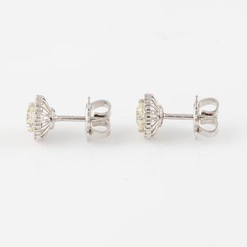 A pair of earrings in 18K white gold with round brilliant-cut diamonds.