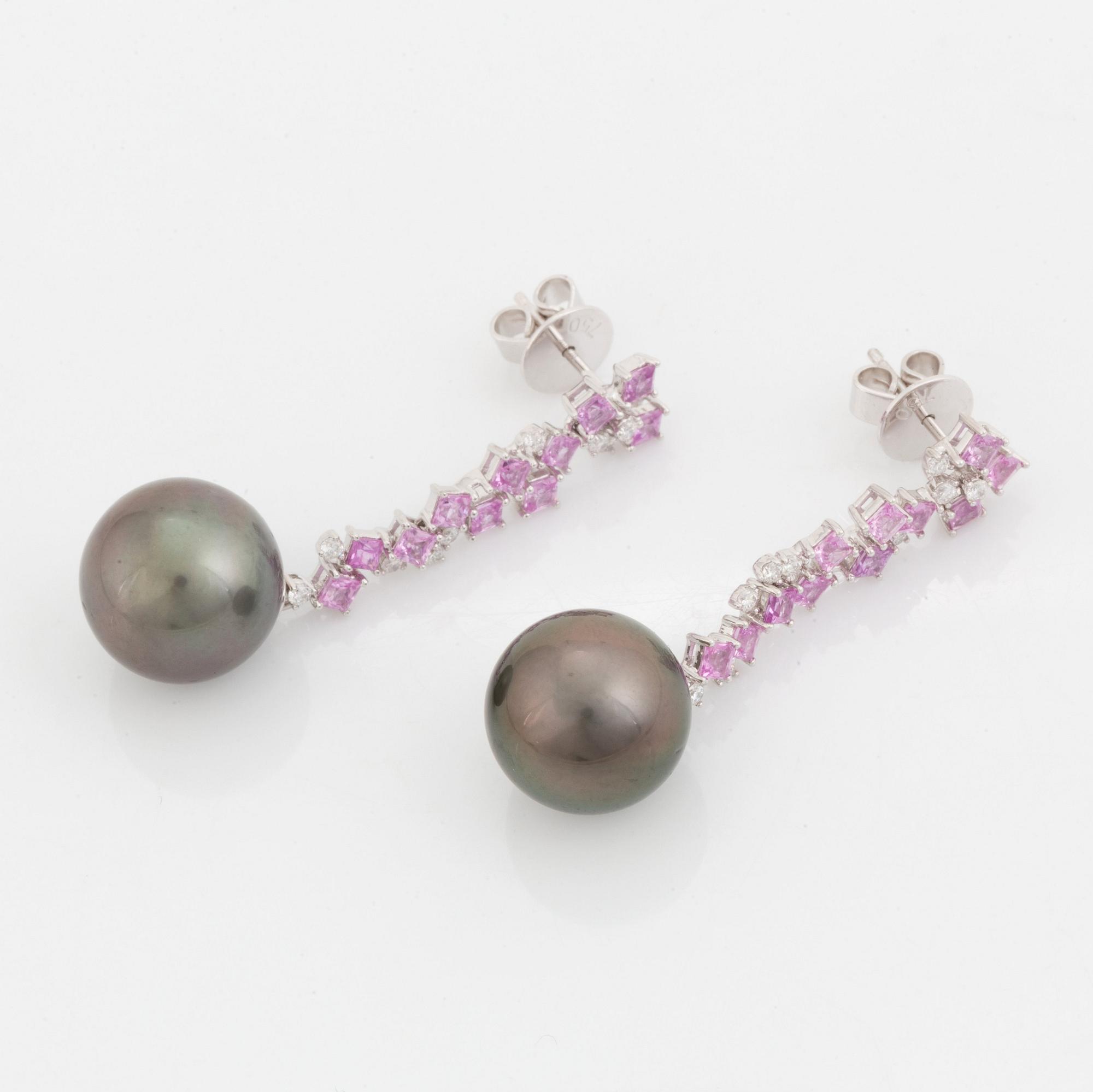 A pair of 18K white gold earrings set with Tahitian cultured pearls and round brilliant-cut diamonds.