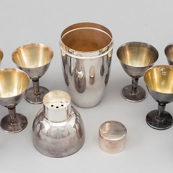 A silverplated shaker and 12 cocktail glasses from GAB and and a Shaker from CG Hallberg, Stockholm mid 20th century.