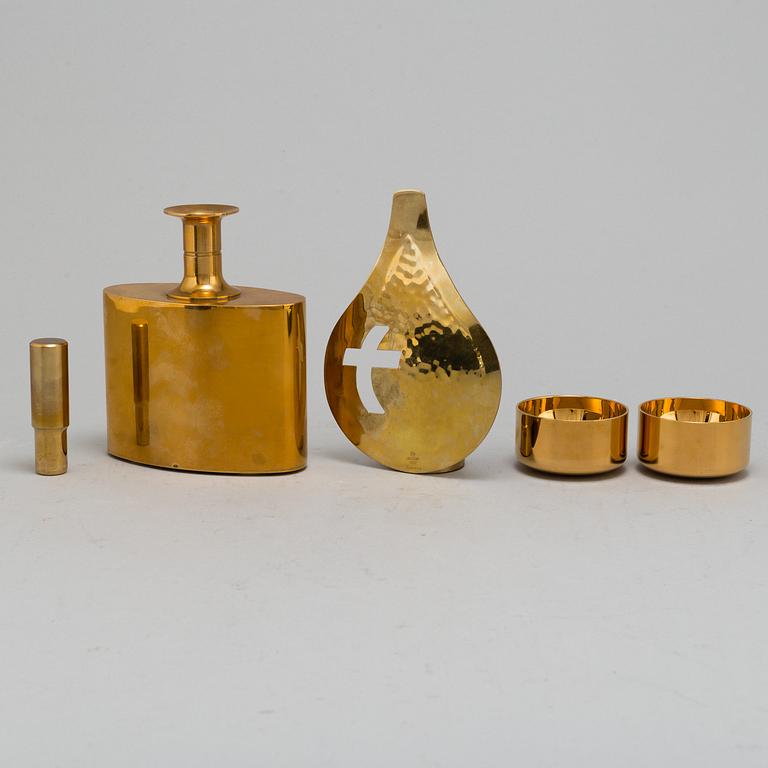 PIERRE FORSSELL, six gilt brass cups and a bottle, as well as candle holder, from Skultuna Bruk.