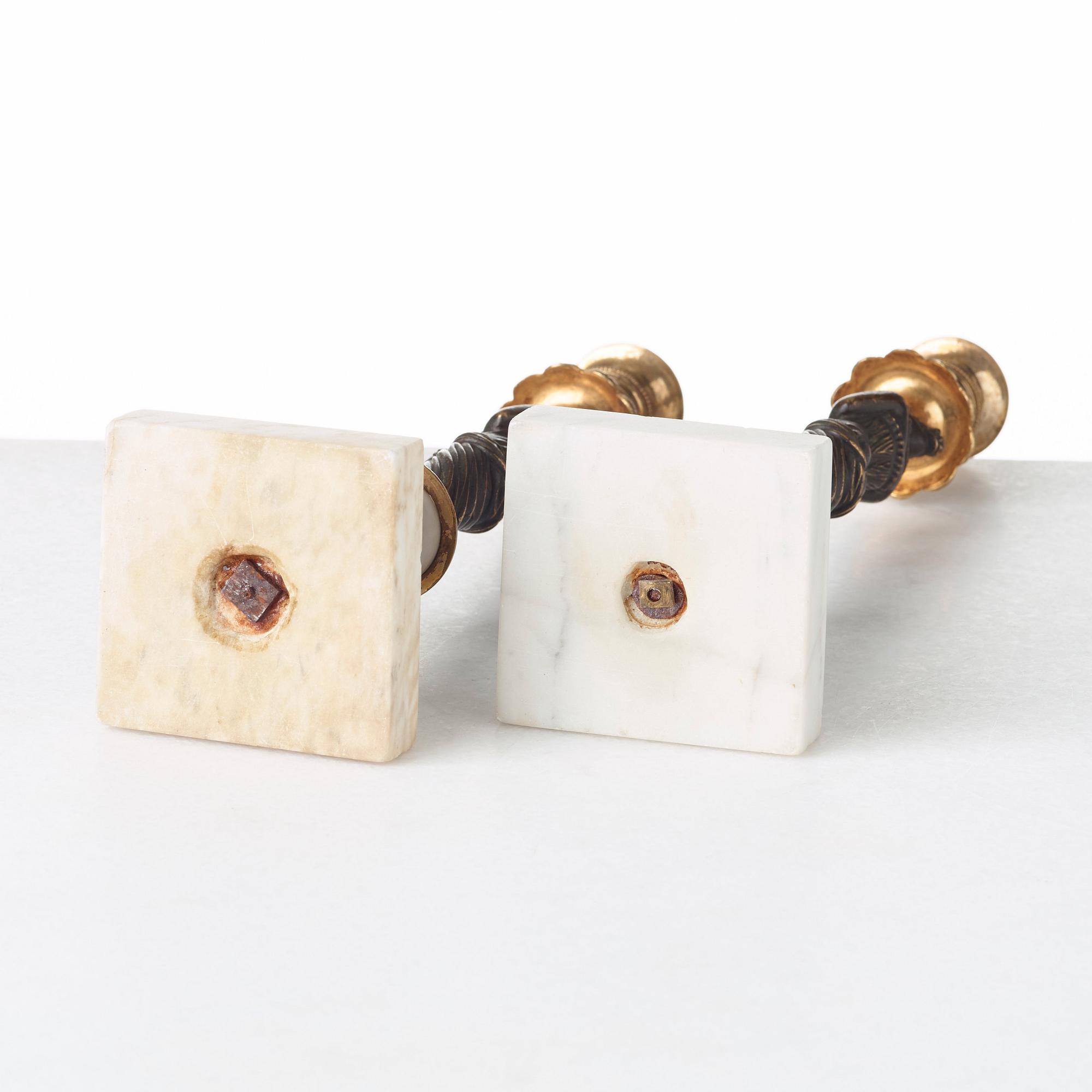 A pair of late Gustavian circa 1800 white marble and bronze candlesticks.