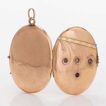 A 14K gold medallion/pendant, with demantoids and a garnet glass doublet. Odessa 1908-1926.