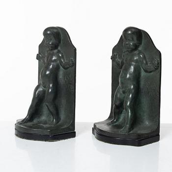 Axel Gute, a pair of patinated bronze bookends, dated 1920.