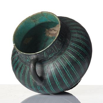 A Kashan Silhouette ware turquoise glazed pottery jug, central Iran, circa 1200.