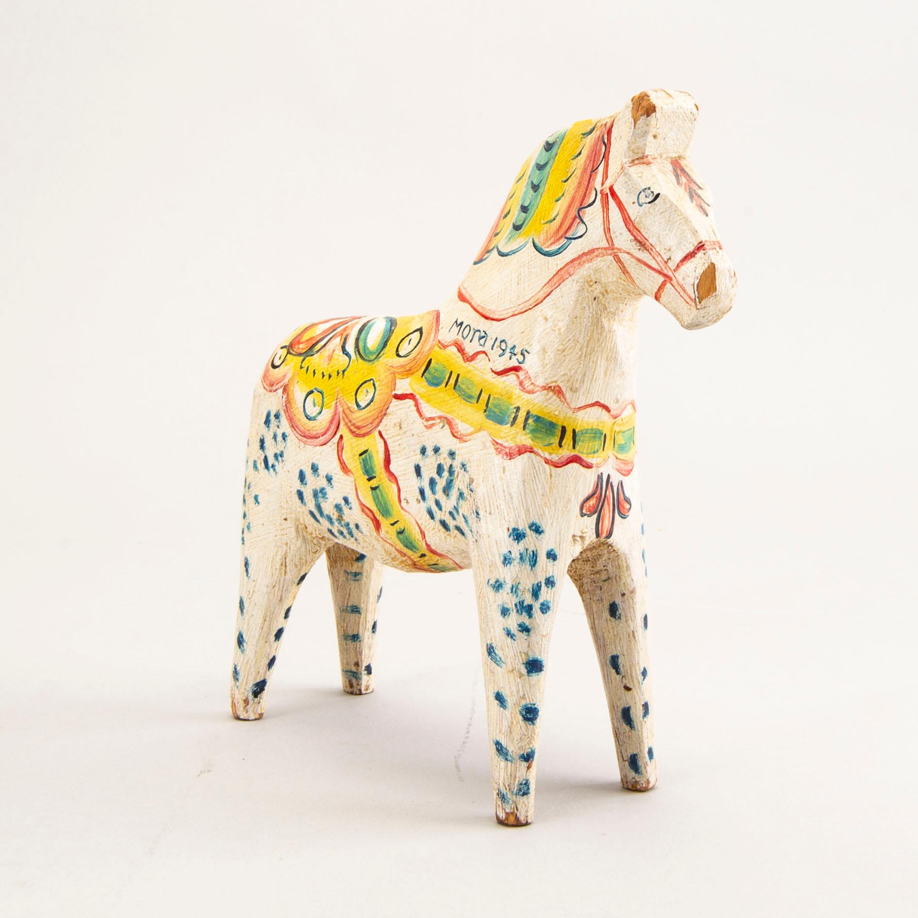 A Swedish painted and dated 1945 wooden horse.