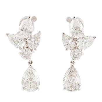 556A. Cartier a pair of earrings platinum set with drop-shaped and round brilliant-cut diamonds.