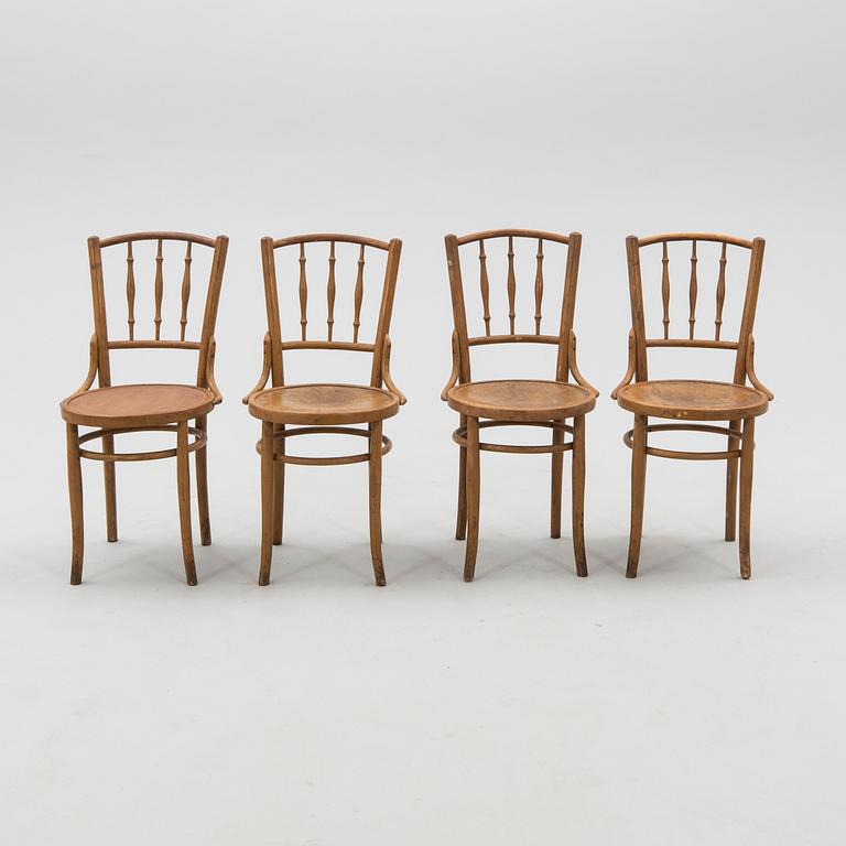 A set of four chairs from the first half of the 20th century.