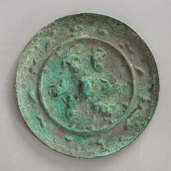 646. A broze mirror, presumably Tang dynasty (618-907 A.D.).