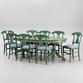 A dining table with eight chairs, Grange, France, late 20th century.
