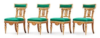 1402. Four late Gustavian early 19th century chairs.