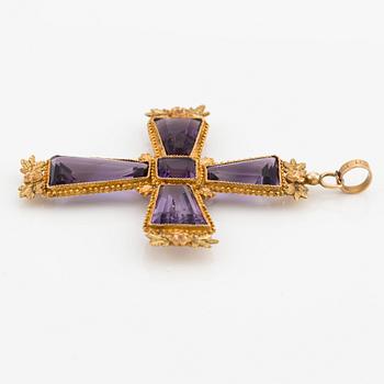 An 18K gold cross with amethysts with a 23K gold chain.