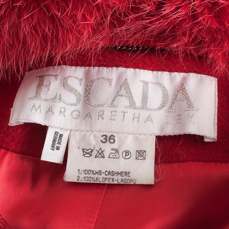 A red cashmere coat with detachable fur neck by Esacada.