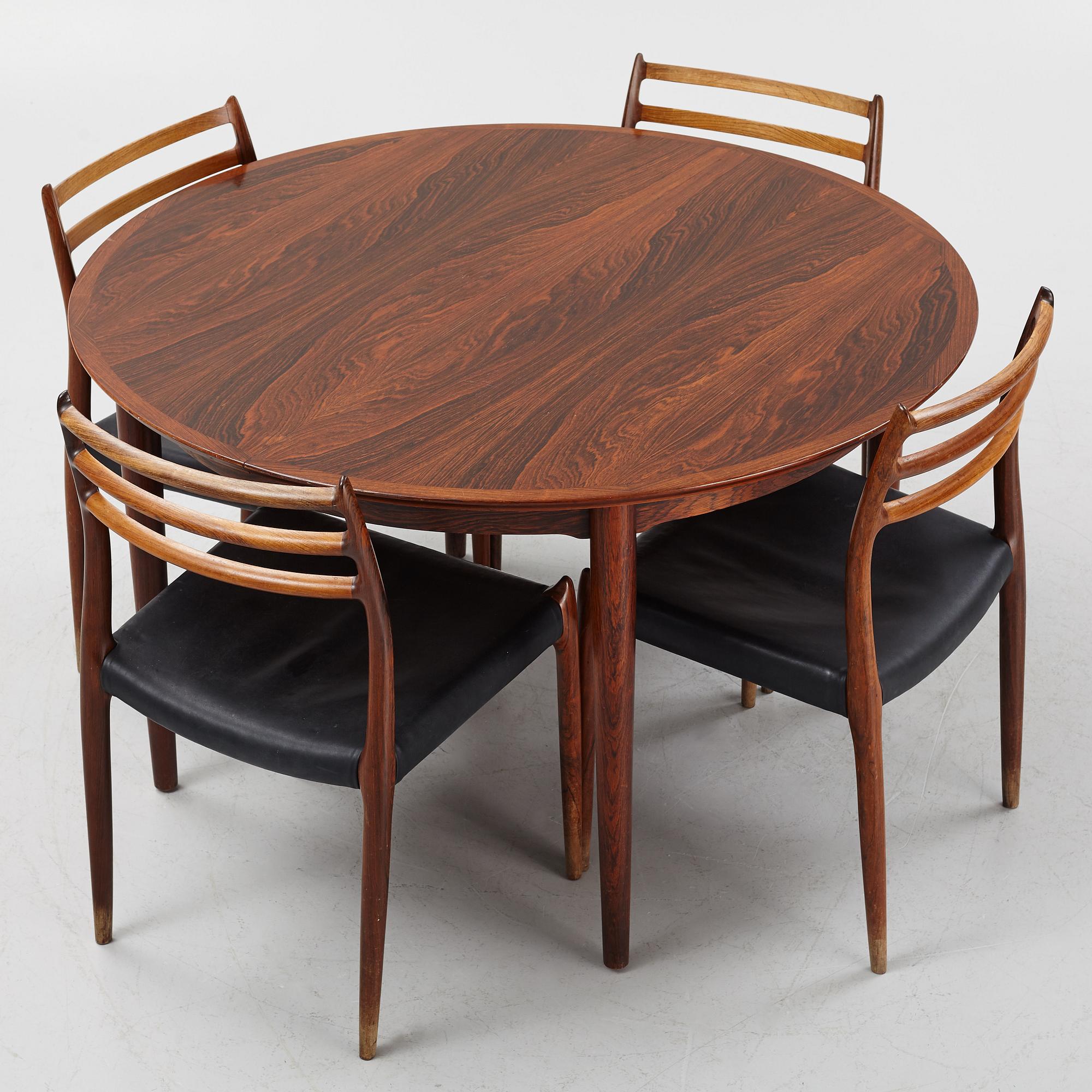 Niles Otto Møller, a rosewood veneered table with four chairs, JL Møller, Denmark, 1950's/60's.