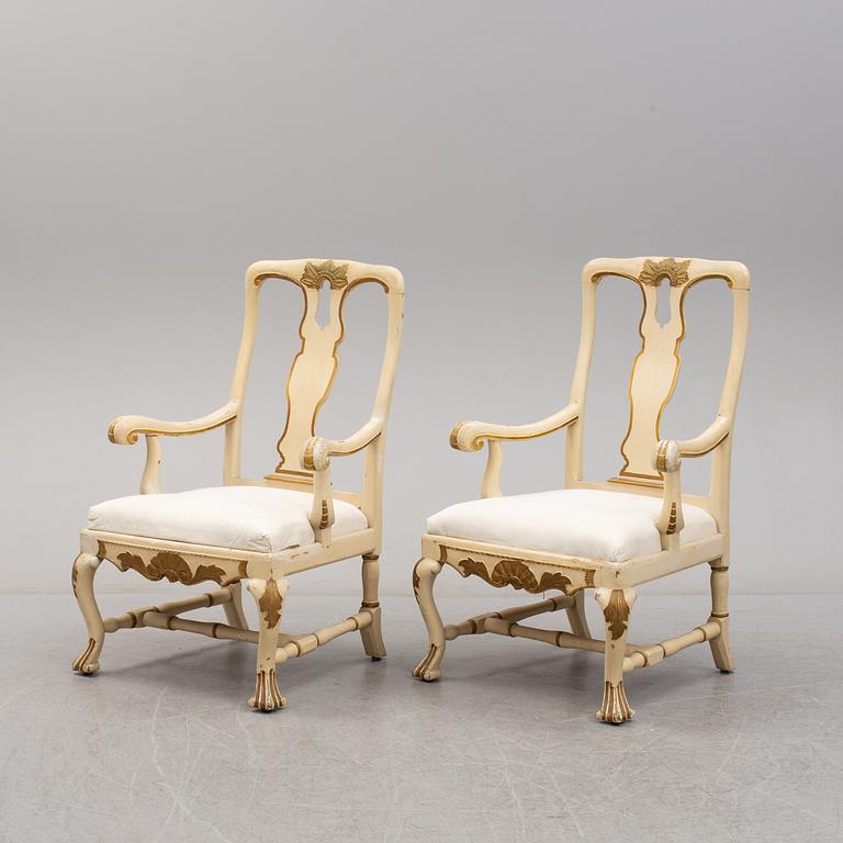 A 19th century pair of late baroque style armchairs.