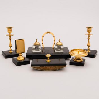 A late 19th Century Desk Set, 6 pcs in brass and stone, incl ink stand and a pair of candle sticks.