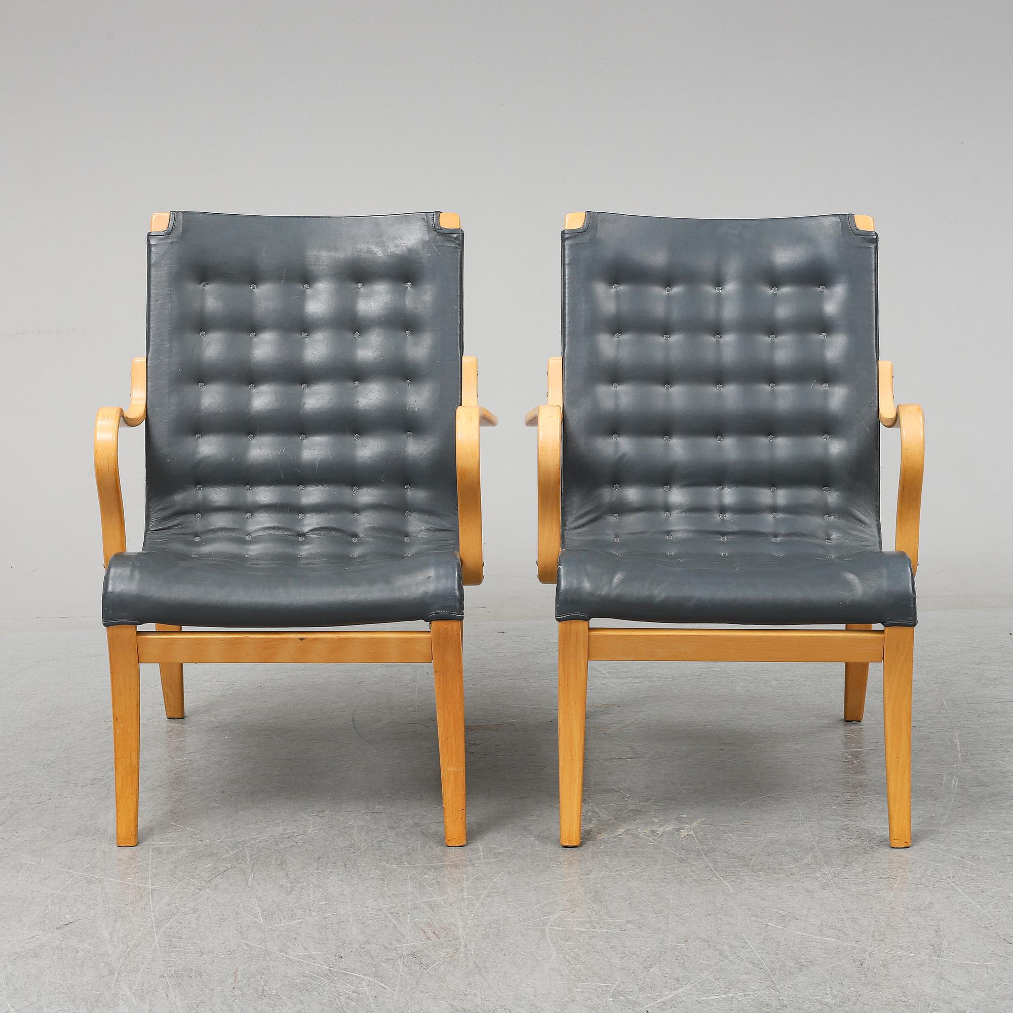 A second half of the 20th Century pair of 'Mina' armchairis by Bruno Mathsson for Mathsson International.