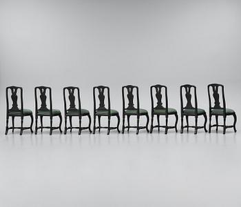 A set of eight black Swedish rococo chairs.