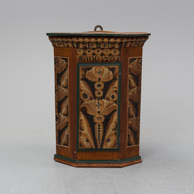 A painted corner cabinet, dated 1794.