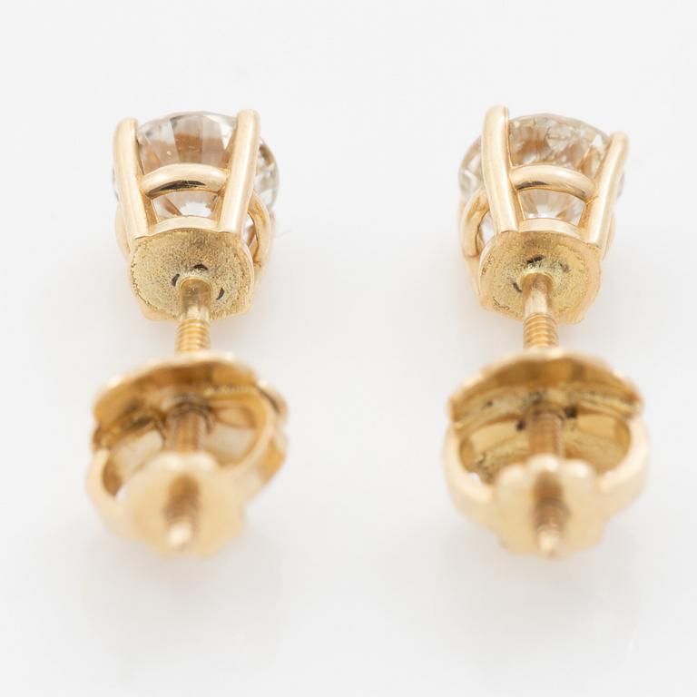 A pair of 14K gold earrings with round brilliant-cut diamonds.
