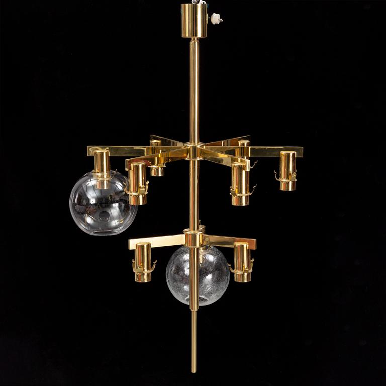 A brass chandelier with two glass globes by Hans-Agne Jacobsson, Markaryd.
