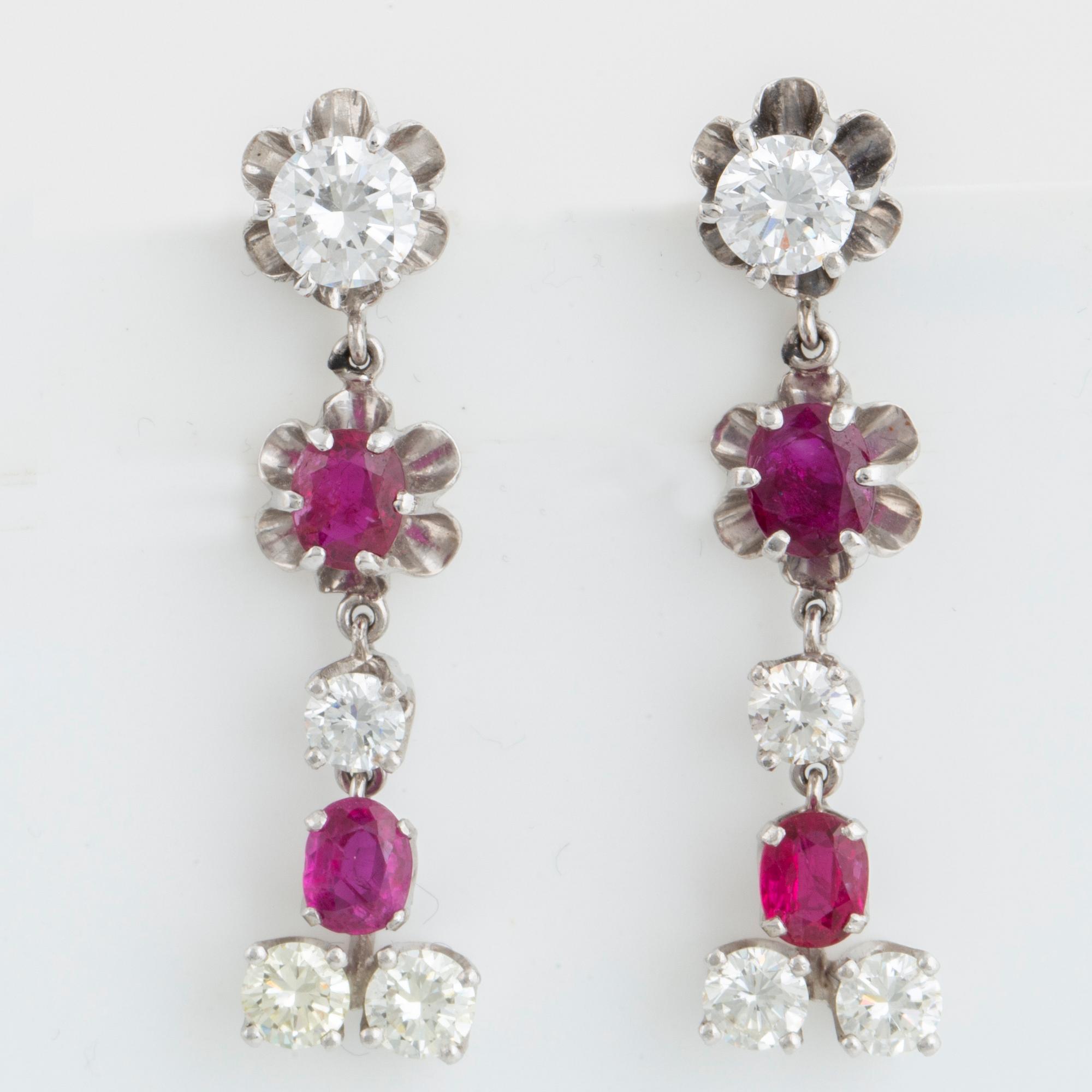 Oval faceted ruby and brilliant-cut diamond earrings.