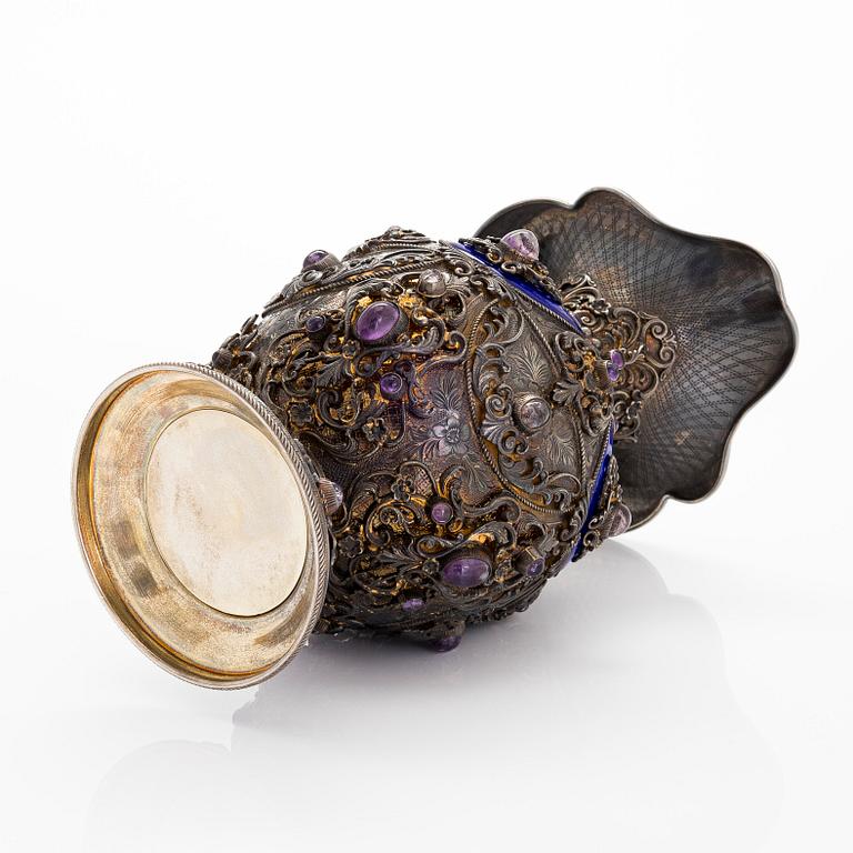 A parcel-gilt silver jug with enamel, and cabochon cut amethysts. First half of the 20th century.