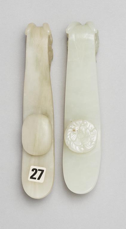 Two pale green garment hooks, Qing dynasty.