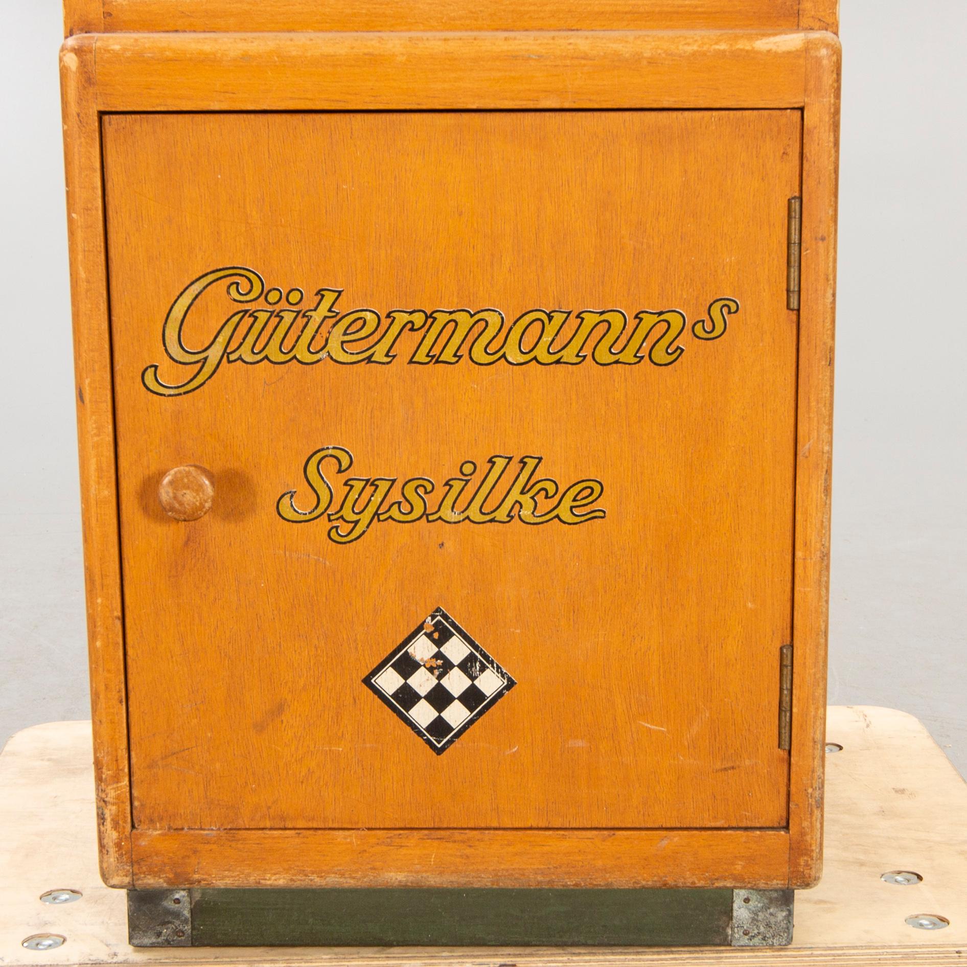 A display cabinet marked  "Gütermanns Sysilke", 1940s.