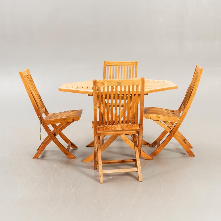 A set of four chairs and a table Royal teak and others, later part of the 20th century.
