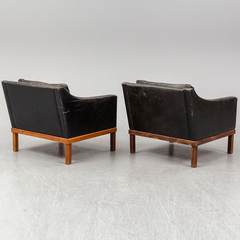 A pair of "The President" black leather armchairs by Ingemar Thillmark for OPE-möbler, Sweden.