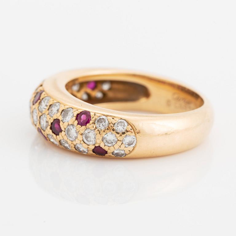 An 18K gold Cartier ring set with round brilliant-cut diamonds and rubies.