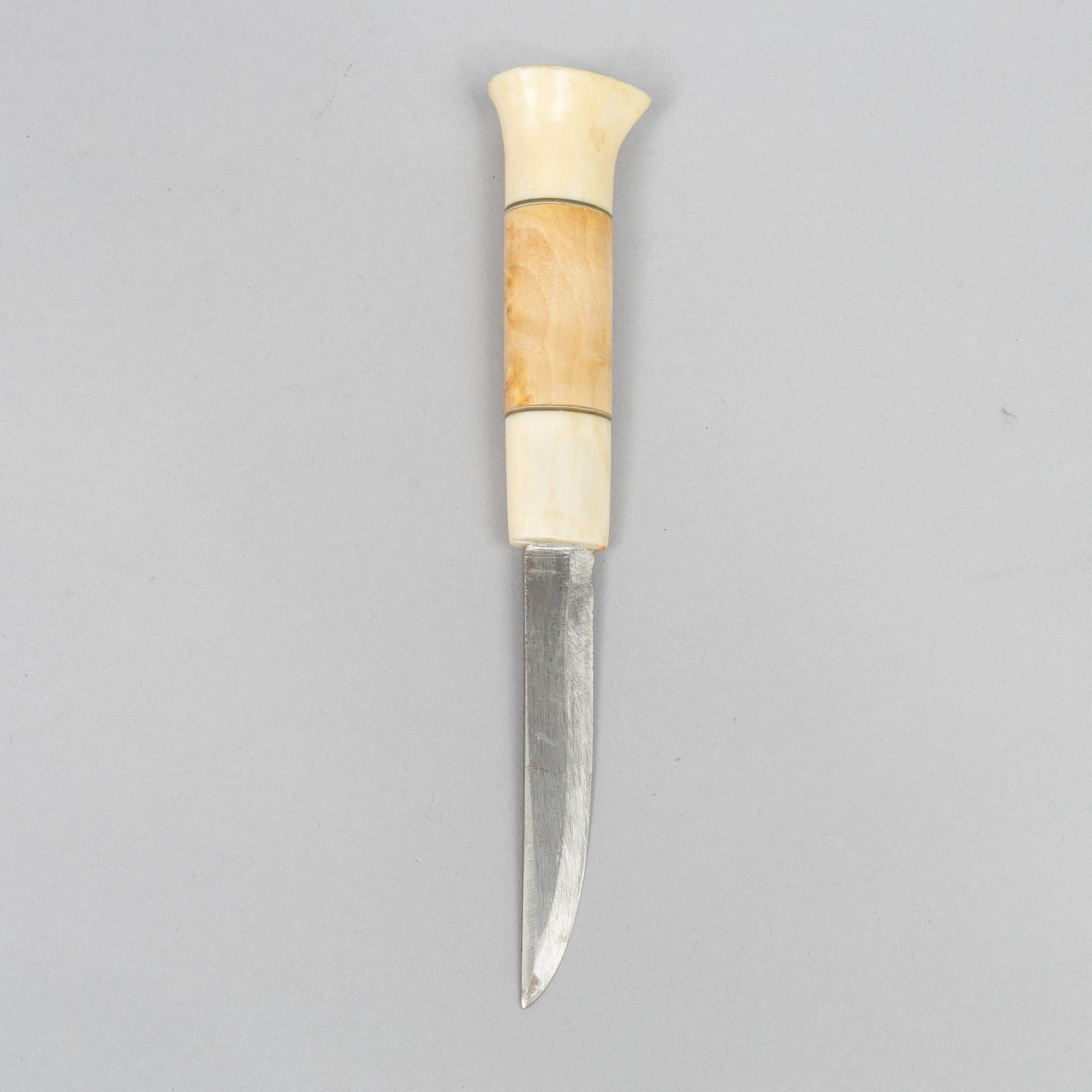 Oskar Tjäder, A reindeer horn knife, signed.