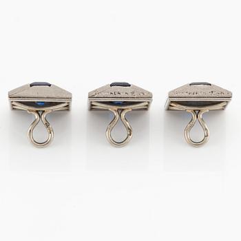Three platinum Boucheron shirt buttons with step-cut sapphires.