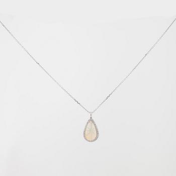 A cabochon cut white opal and brilliant cut diamond pendant.