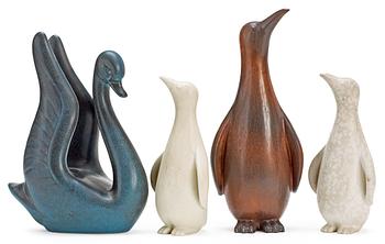 Four Gunnar Nylund stoneware figures, a swan and three penguins, Rörstrand.