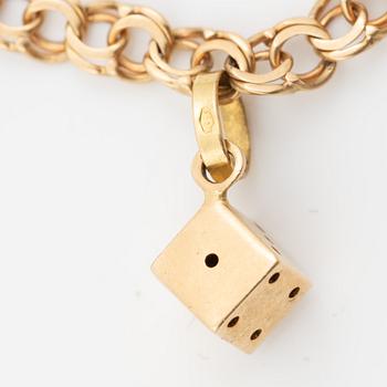 Bracelet, 18K gold bismarck link. With charms.