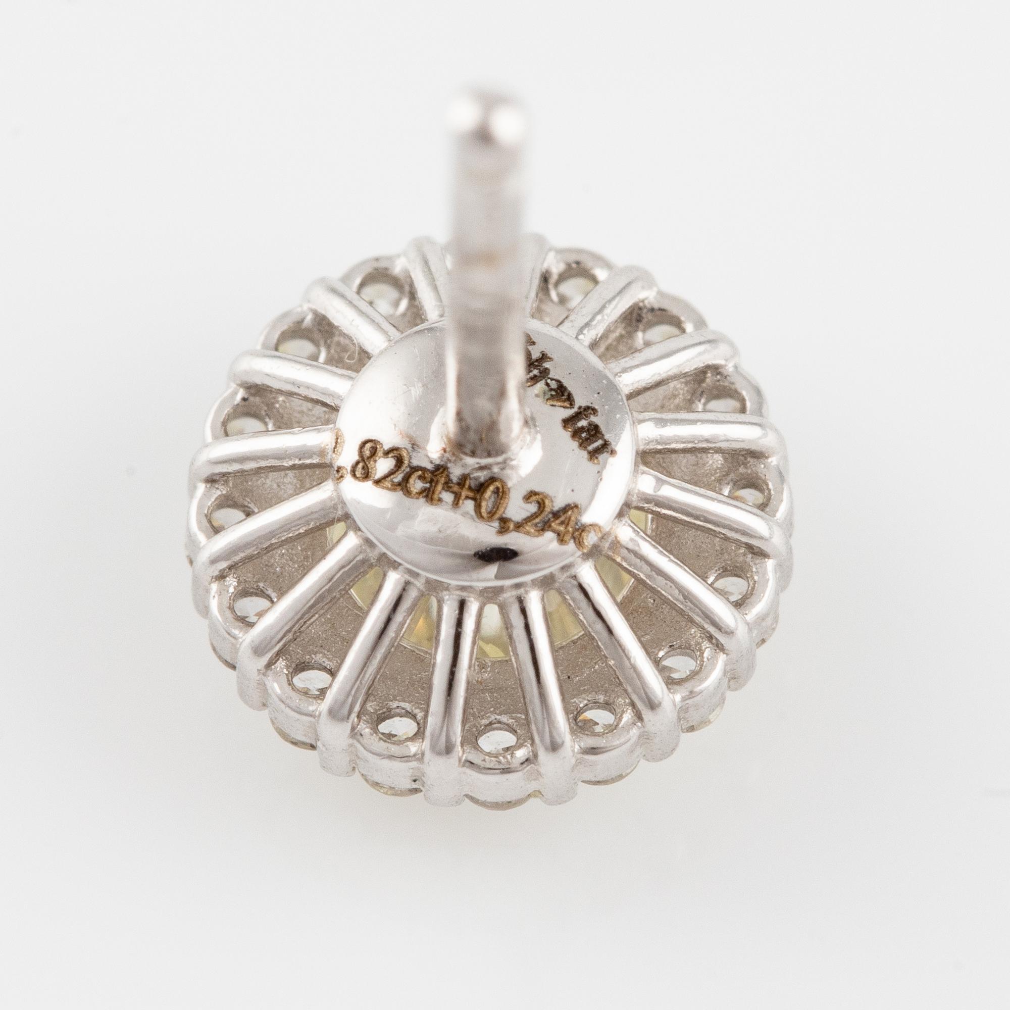 A pair of earrings in 18K white gold with round brilliant-cut diamonds.