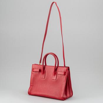Saint Laurent, a red leather 'Sac du Jour Small' bag.
