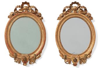 A pair of late Gustavian two-light giltwood girandoles by J. Frisk (active 1805-1824).