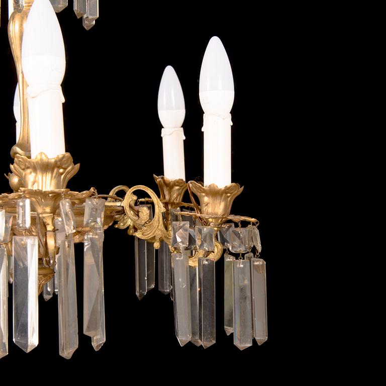 A brass chandelier with prisms, late 19th century. Height 75 cm.