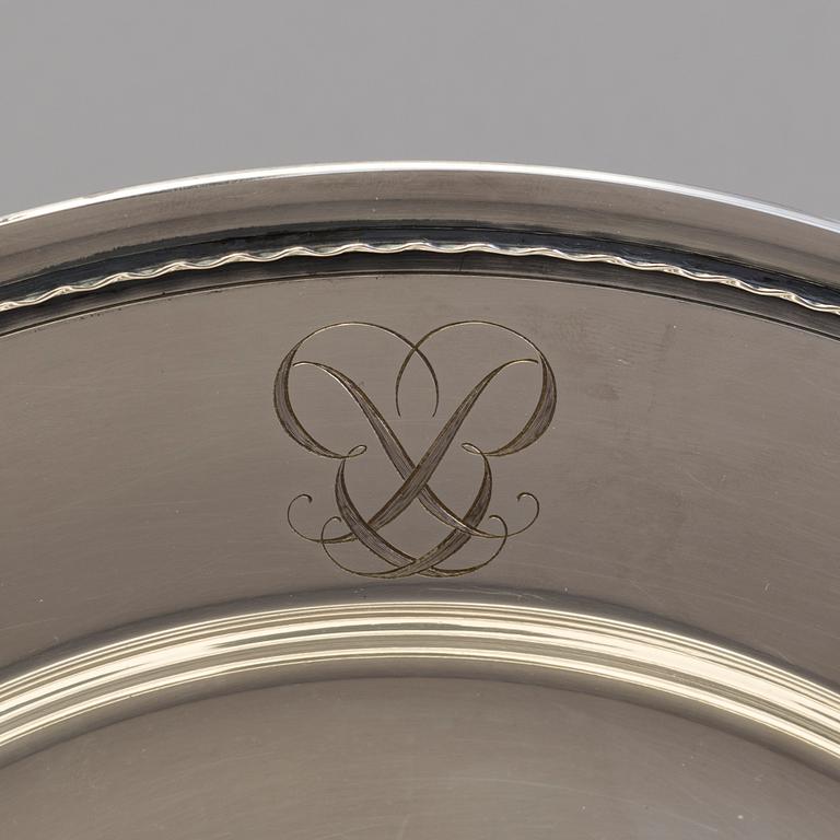Four monogrammed Swedish silver charger plates, Makers's mark GAB, Stockholm, 1949.