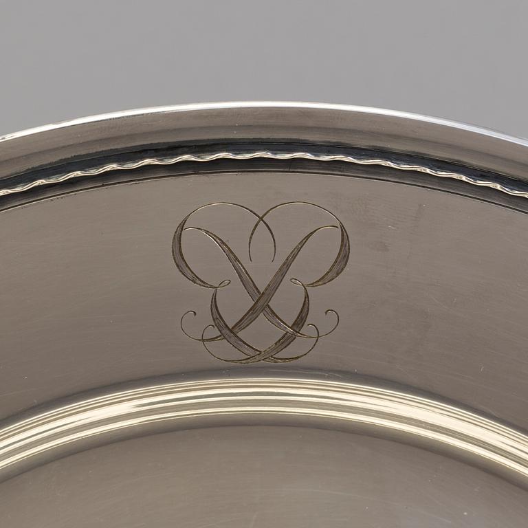 Four monogrammed Swedish silver charger plates, Makers's mark GAB, Stockholm, 1949.