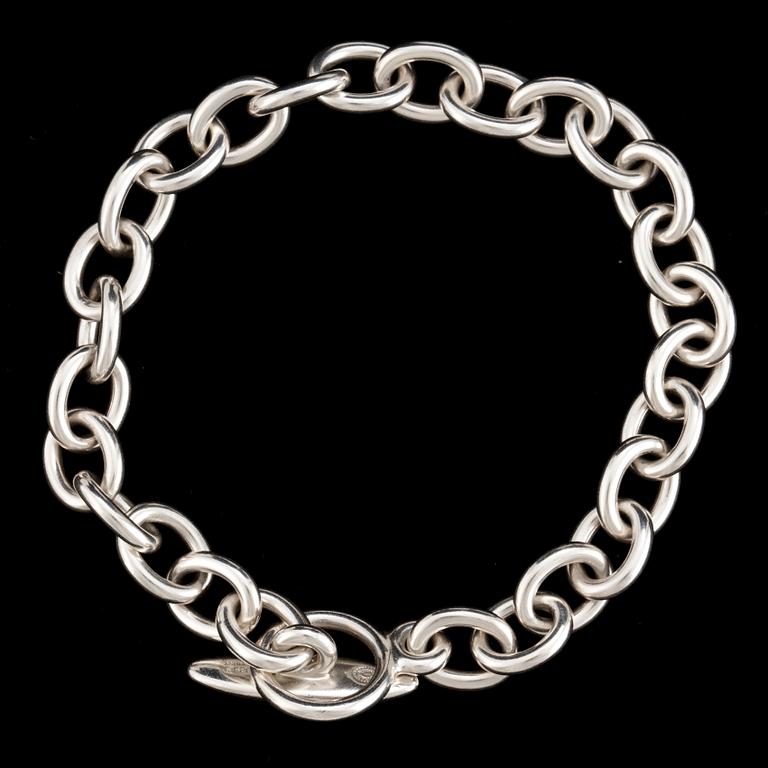 A silver bracelet and three charms by Georg Jensen, after 1945.