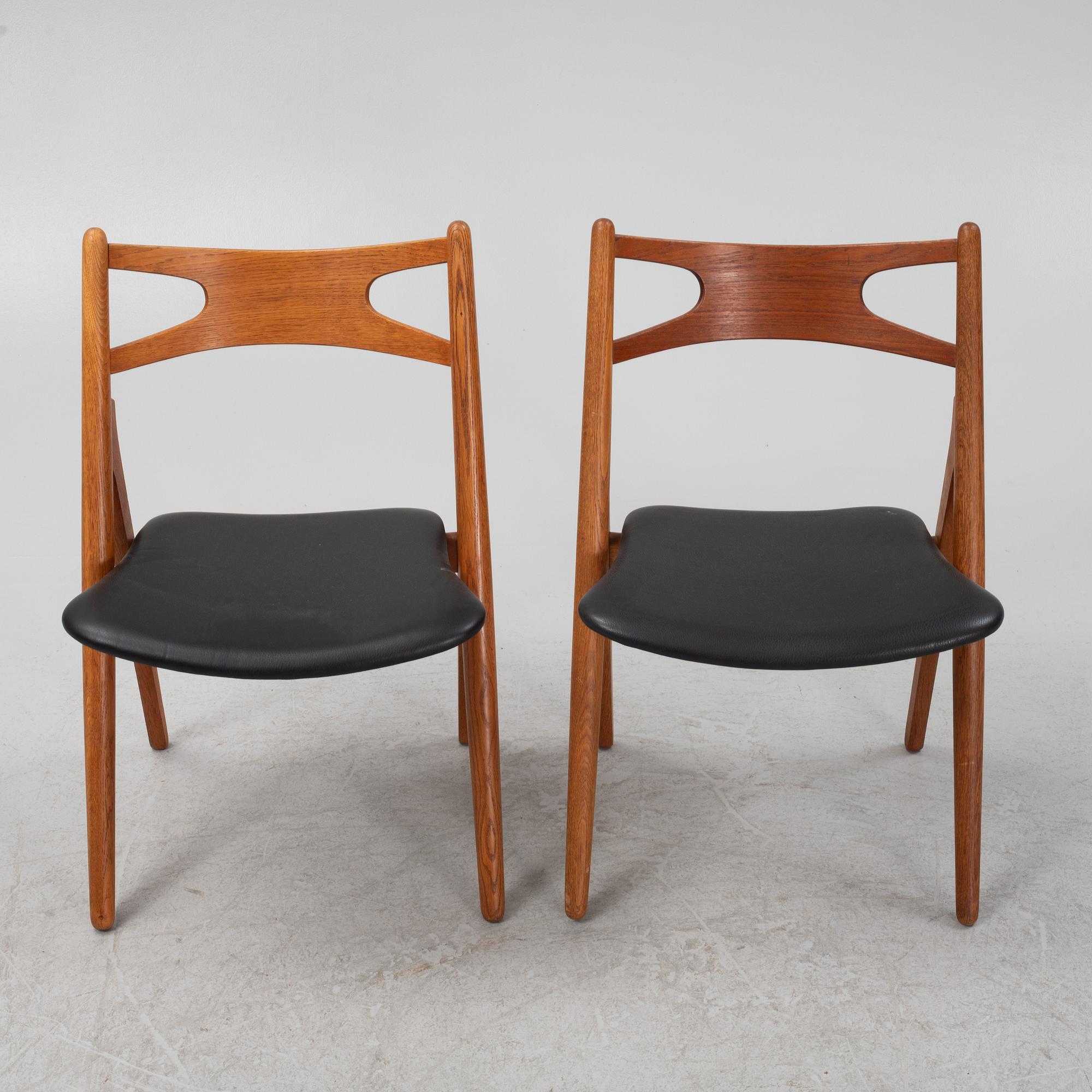Hans J Wegner, a pair oak and teak CH29 'Savbukkestolen' chairs,Carl Hansen, mid 20th century.