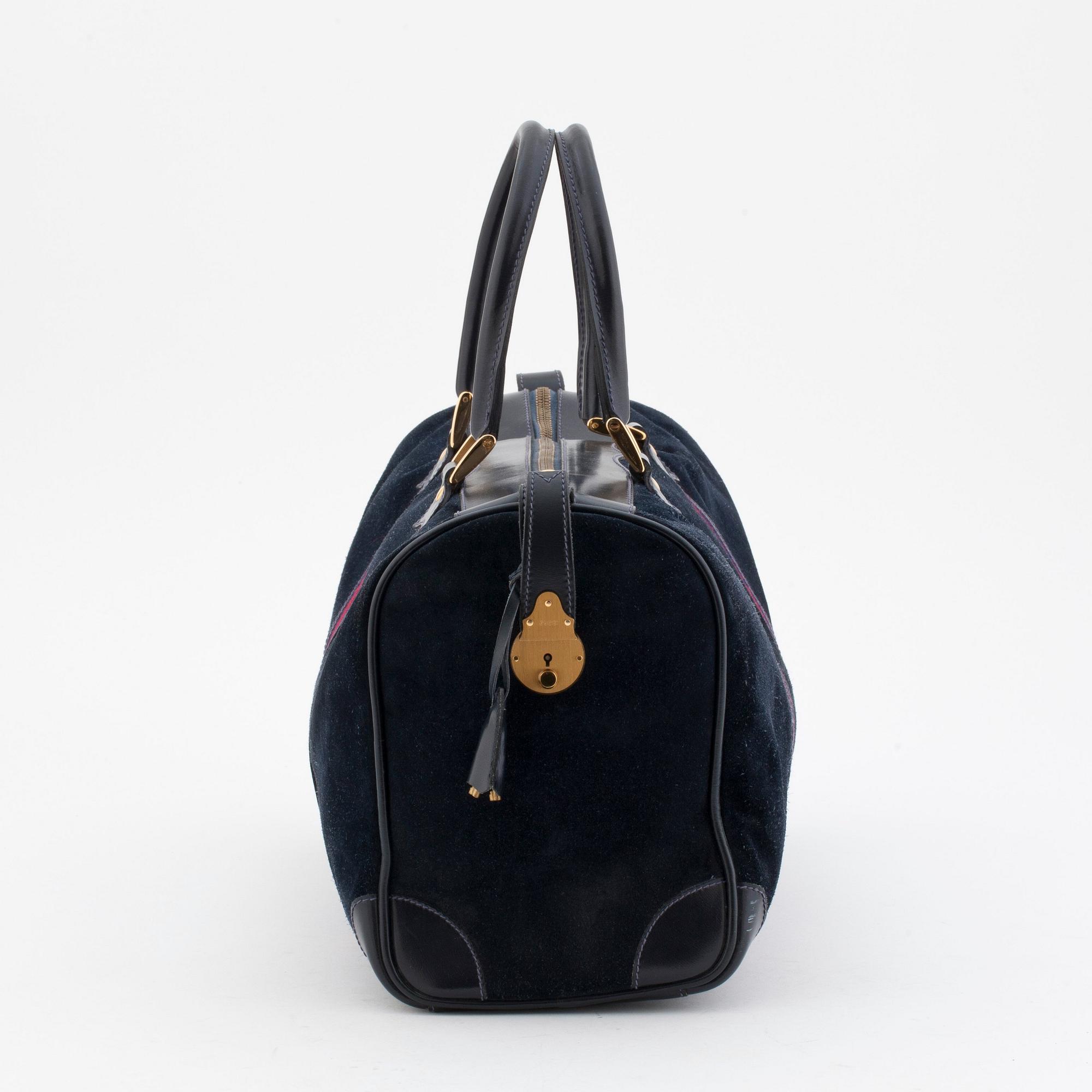 GUCCI, a blue suede and leather weekendbag.