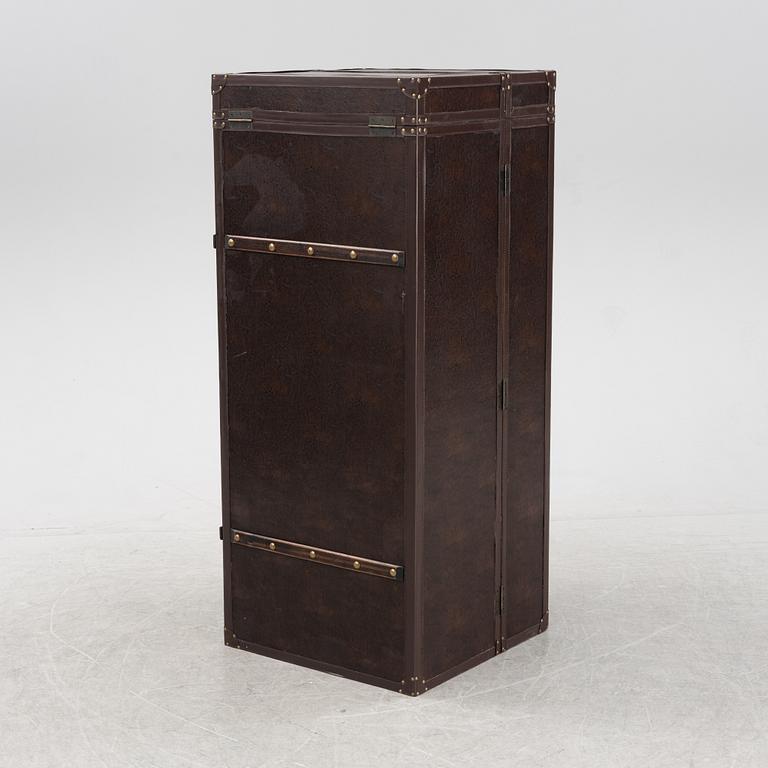 A leather suitcase-shaped bar cabinet.