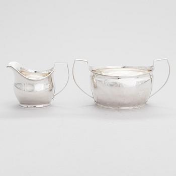 An early 19th-century, sterling silver sugar bowl, mark of Elizabeth Morley, and a cream jug, marked A.B, London 1808.