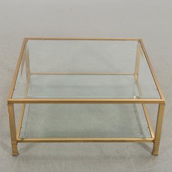 A GLASS TOP COFFEE TABLE.