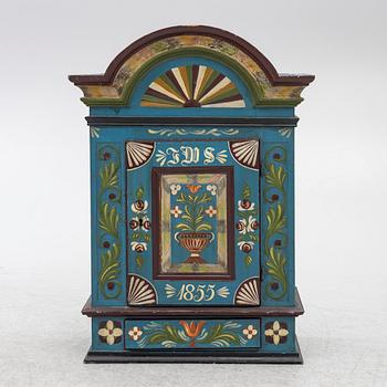 A 19th century folk art hanging cabinet.